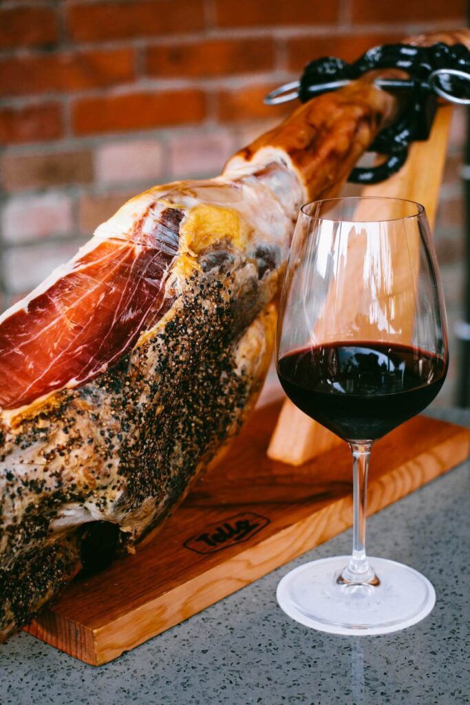 un prosciutto e un bicchiere di vino rosso