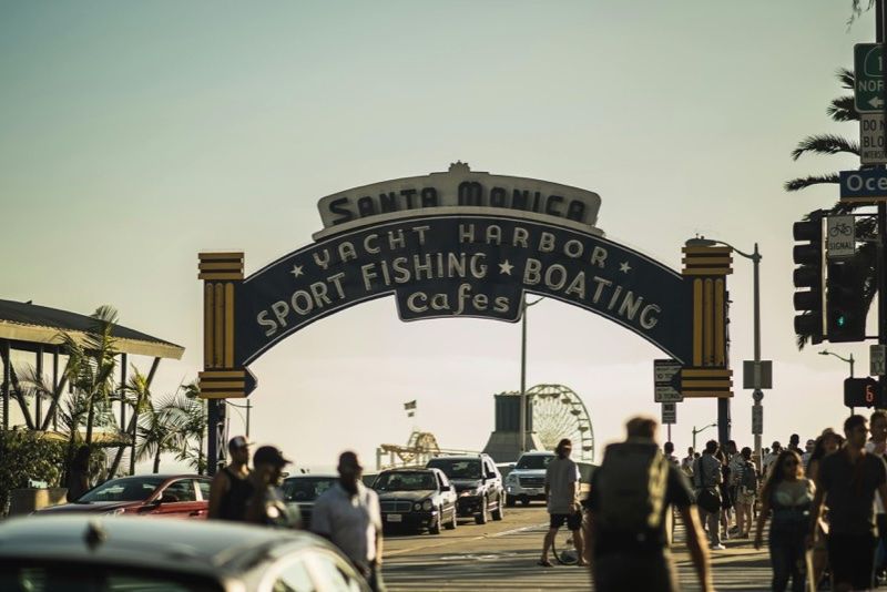 Ingresso di Santa Monica con persone e auto vicino al molo