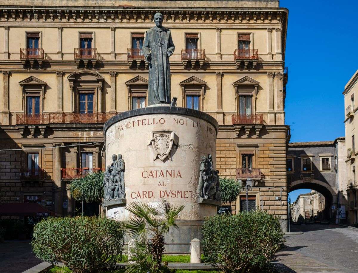 Monumento al cardinale Dusmet davanti a un palazzo storico nel centro di Catania