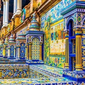 Una fachada ornamentada de un edificio con columnas y bancos, completamente cubierta de azulejos cerámicos de colores azul y amarillo.