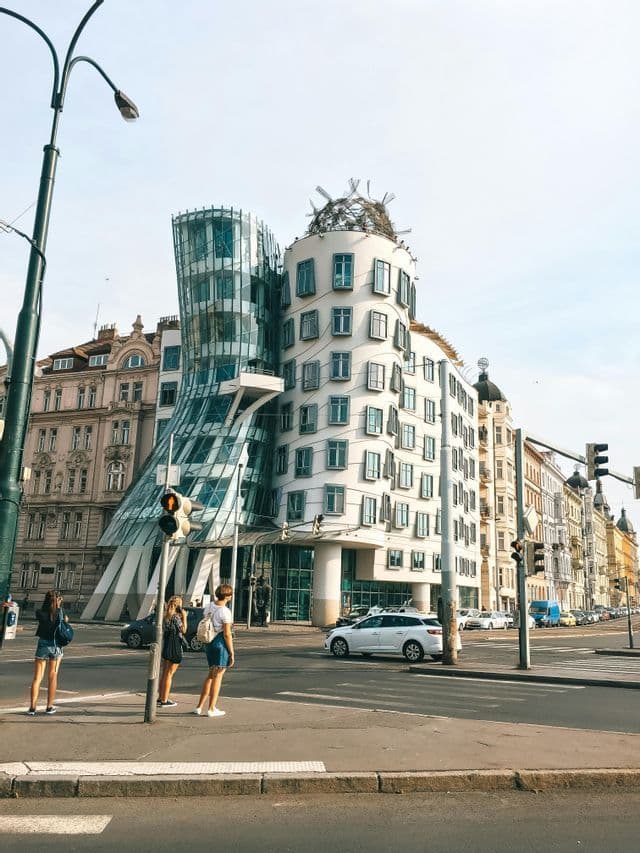 The curved glass facade of the Dancing House in Prague.