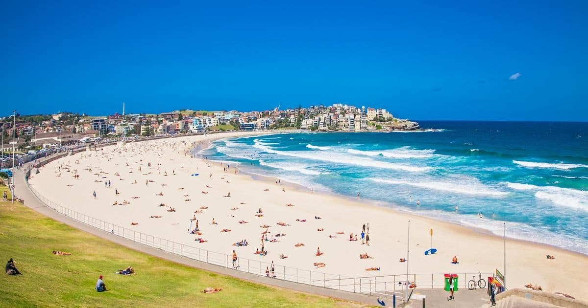Bondi Beach Bondi Beach from the coastal path, a crescent of pale sand and turquoise surf lined with houses.