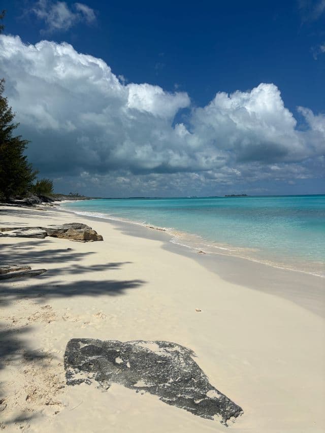 Empty white sand beach with turquoise water in the Bahamas