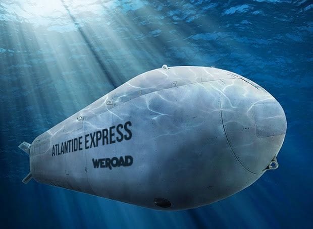 Un sottomarino grigio con i marchi "ATLANTIDE EXPRESS" e "WEROAD" viaggia sott'acqua mentre la luce del sole filtra attraverso la superficie dell'oceano.