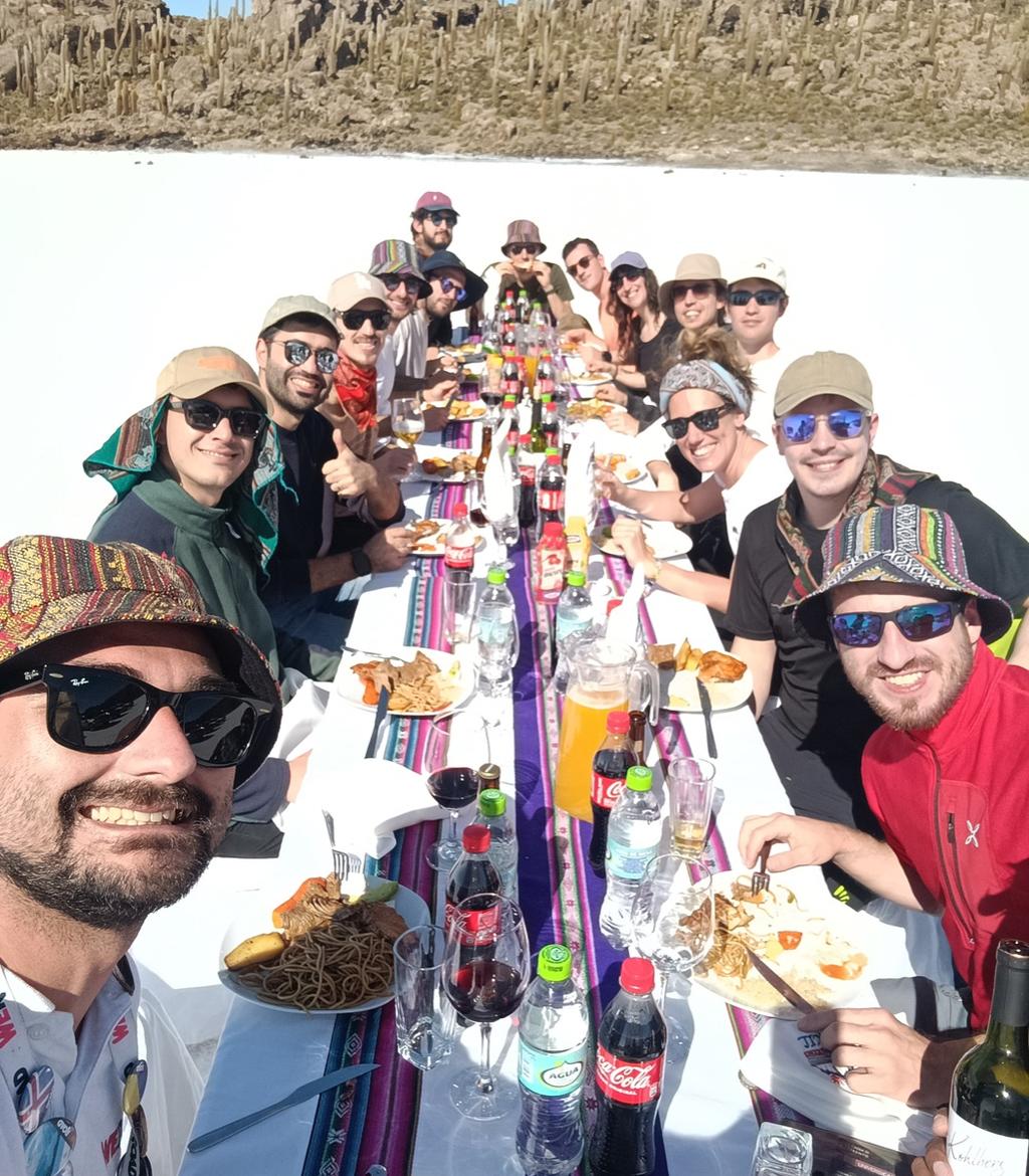 Spooners having lunch at one long table set on the Uyuni salt flat