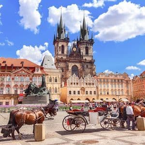 Horse-drawn carriages in Prague's Old Town Square in front of the Church of Our Lady before Tyn.