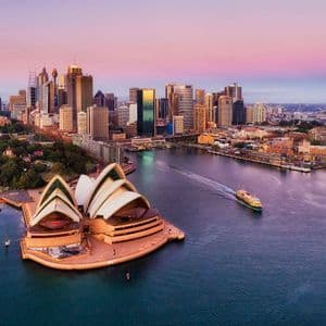 Sydney harbour and the Opera House at sunset Sydney harbour at sunset seen from above, with the Opera House in the foreground and the downtown skyline behind it.