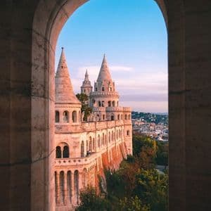 The white turrets of the Fisherman's Bastion above Budapest at sunset.
