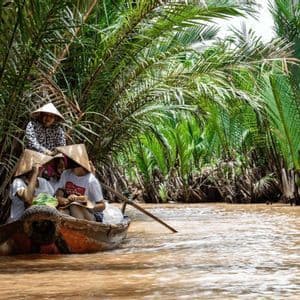 Mekong Delta canal A boat with conical hats along a canal in the Mekong Delta