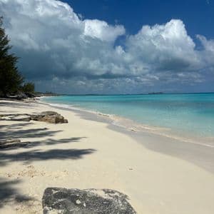 Empty white sand beach with turquoise water in the Bahamas